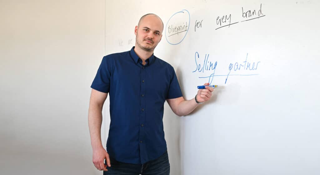 Frame 1 A guy wrote Selling partner on a backboard